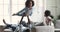 Happy afro american father and kids playing in living room