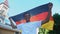 Happy afro-american teen male waving Germany flag and smiling, patriots march