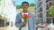 Happy afro-american young male holding tulips bouquet and smiling on camera gift