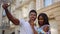 Happy afro couple making selfie in old city. African tourists posing on street