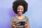 Happy Afro girl using mobile smartphone outdoor - Smiling social influencer woman having fun with new trends technology apps