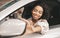 Happy Afro Lady Sitting In Driver`s Seat In Car Dealership Center