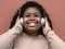 Happy Afro Latin girl having fun listening music with wireless headphones