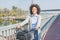 Happy Afro woman with bicycle outdoor portrait