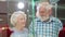 Happy aged couple choosing jewelry in shopping mall