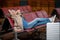 Happy aged lady is relaxing on bench at waiting hall