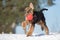 happy airedale terrier puppy playing outdoors in winter