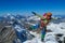 Happy alpine climber on snow mountain ridge