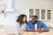 Happy amazed African-American couple with laptop at home