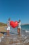 Happy amorous couple on the beach with a big heart balloon. Summer love concept