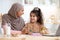 Happy Arab Family Mom And Little Daughter Drawing Together In Kitchen