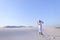 Happy Arab man walks in middle of white desert and enjoys life o