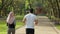Happy arabian couple in active wear jogging at green park during morning time. Young man and woman enjoying time