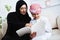 Happy Arabic child at home with his mother