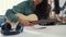 Happy asia woman songwriter play acoustic guitar listen song from smartphone think and write notes lyrics song in paper sit in