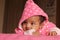 Happy asian baby girl in pink sweater