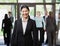 Happy Asian businesswoman holding briefcase