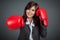 Happy Asian businesswoman punch with boxing glove
