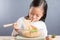 Happy Asian child eating delicious noodle