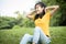 Happy asian child girl resting feel comfortable at park,female teenager with hands behind her head and closed eyes,healthy woman