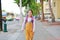 Happy Asian child girl walking with student shoulder schoolbag. Little schoolgirl with a backpack front view. Back to school