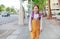 Happy Asian child girl walking with student shoulder schoolbag. Little schoolgirl with a backpack front view. Back to school