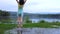 Happy asian child having fun and kicking water at lake