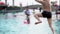 Happy asian child running and jumping in to the pool.Slow motion 120 FPS