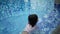 happy asian Chinese child girl takes off face mask to have swim in the pool