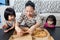 Happy Asian Chinese Family Enjoying Pizza Together