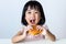 Happy Asian Chinese little girl Eating Burger