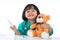 Happy Asian Chinese little girl examine teddy bear with thermometer