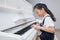 Happy Asian Chinese little girl playing classical piano at home