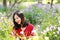 Happy Asian Chinese woman beauty girl smile in a flower field in a spring summer autumn park selfie