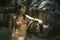 Happy Asian Chinese woman in bikini enjoying unique Summer holidays at tropical forest refreshing relaxed in natural pool