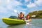 Happy asian couple kayaking together on the beatiful sea or canoe at tropical bay