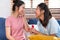 Happy asian couple lesbian proposal with ring for marry at living room at home.LGBTQ lifestyle concept