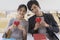 Happy asian couple in love sitting in classroom, holding red heart shape, love symbol