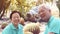 Happy Asian elderly couple smile laugh in cactus garden leisure walk in nature