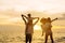 Happy asian family on the beach in holiday. of the family holding hands, Son and daughter piggyback on parents.They are having fun