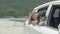 Happy asian family driving a car go to travel trip with excited on the beach for recreation together in vacation, happy children