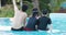 Happy asian family enjoying playing together swimming pool at water theme park