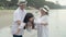 Happy asian family with father and mother relax carrying with daughter on vacation together in the beach