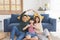 Happy Asian family gesture new building residential house together on sofa at home living room. insurance protect concept