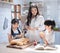 Happy asian family in the kitchen. mother and son and daughter spread strawberry yam on bread, leisure activities at home