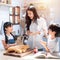 Happy asian family in the kitchen. mother and son and daughter spread strawberry yam on bread, leisure activities at home