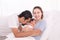 Happy Asian family lifestyle, father hold wife kissing toddler newborn baby with love, mother hug infant in arm sleeping comfort