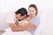 Happy Asian family lifestyle, father hold wife kissing toddler newborn baby with love, mother hug infant in arm sleeping comfort