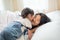 Happy Asian family loving children, kid and her sister kissing and relaxing together in bed