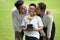 happy asian Family, parents and their children holding trophy  in park together. father and mother embracing and kiss son